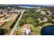 Aerial view of property with pond, trees, and neighborhood at 10120 Lakeshore Dr, Clermont, FL 34711