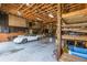 Expansive garage space with beamed ceiling, storage, and classic white car at 10120 Lakeshore Dr, Clermont, FL 34711