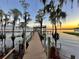 Long wooden dock stretches out into a calm lake, offering scenic views and access to the water at 1241 W Lakeshore Dr, Clermont, FL 34711