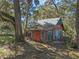 Rustic, two-story home with a metal roof, nestled among trees offering a unique, secluded setting at 13524 Corkwood Ln, Astatula, FL 34705