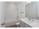 Clean bathroom with tub, vanity, and tile flooring at 13200 Peaceful Melody Dr, Winter Garden, FL 34787