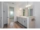 Modern bathroom with double vanity and a view into bedroom at 13200 Peaceful Melody Dr, Winter Garden, FL 34787