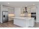 Modern kitchen with island, stainless steel appliances, and white cabinets at 13200 Peaceful Melody Dr, Winter Garden, FL 34787