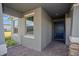 Covered entryway with navy blue front door and stone accents at 13230 Peaceful Melody Dr, Winter Garden, FL 34787