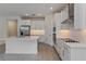 Modern kitchen with white cabinets, stainless steel appliances, and island at 13230 Peaceful Melody Dr, Winter Garden, FL 34787