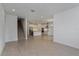 Open living area with view into kitchen and stairs at 13230 Peaceful Melody Dr, Winter Garden, FL 34787