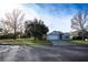 Tan one-story house with a two-car garage and well-maintained lawn at 3103 Merlot Way, Clermont, FL 34714