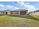 Spacious backyard with a covered patio, perfect for outdoor entertaining and relaxation at 2720 Dumont Ln, Tavares, FL 32778