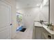 Well-lit bathroom with a double vanity, modern fixtures, and decorative shower curtain at 2720 Dumont Ln, Tavares, FL 32778