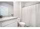 Bathroom with white vanity, toilet, shower with curtain, and gray countertop at 2720 Dumont Ln, Tavares, FL 32778