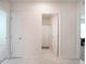 Neutral colored wall and floor tiles, with white bathroom and bedroom doors at 2720 Dumont Ln, Tavares, FL 32778