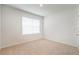 Bedroom with neutral carpet, one window with blinds, and white walls at 2720 Dumont Ln, Tavares, FL 32778