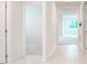 Bright hallway with tile flooring, leading to rooms with neutral carpeting at 2720 Dumont Ln, Tavares, FL 32778