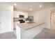 Kitchen with island, white cabinets, stainless appliances, and adjacent pantry at 2720 Dumont Ln, Tavares, FL 32778