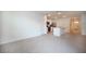 Open-concept living room flows into kitchen with stainless appliances and a breakfast bar at 2720 Dumont Ln, Tavares, FL 32778