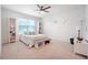 Bright main bedroom with a ceiling fan, large window, and stylish furniture at 2720 Dumont Ln, Tavares, FL 32778