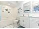 Clean bathroom with double vanity, bathtub, and decorative wall art at 4624 Harbour Village Bv # 4205, Ponce Inlet, FL 32127