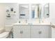 Double vanity bathroom with white cabinets and marble floors at 4624 Harbour Village Bv # 4205, Ponce Inlet, FL 32127