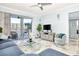 Living room with sectional sofa, balcony access, and marble floors at 4624 Harbour Village Bv # 4205, Ponce Inlet, FL 32127