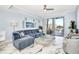 Living room with sectional sofa, balcony access, and marble floors at 4624 Harbour Village Bv # 4205, Ponce Inlet, FL 32127