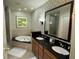 Elegant bathroom with double sinks and a soaking tub at 8495 Miracle Dr # 202, Champions Gate, FL 33896