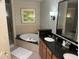 Elegant bathroom with soaking tub, double vanity, and a walk-in shower at 8495 Miracle Dr # 202, Champions Gate, FL 33896