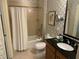 Clean bathroom with tub, toilet and vanity with granite countertop at 8495 Miracle Dr # 202, Champions Gate, FL 33896