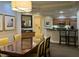 Elegant dining room with a large table and seating for six at 8495 Miracle Dr # 202, Champions Gate, FL 33896