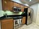 Modern kitchen with stainless steel appliances and granite countertops at 8495 Miracle Dr # 202, Champions Gate, FL 33896