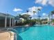 Community pool with adjacent seating and bar at 8495 Miracle Dr # 202, Champions Gate, FL 33896