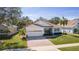 One-story home with a two-car garage and attractive landscaping at 2441 Prairie Dunes, Clermont, FL 34711