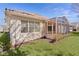 Home exterior showcasing a screened patio and well-manicured lawn at 2441 Prairie Dunes, Clermont, FL 34711