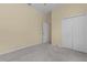 Bedroom with grey carpet, double door closet, and access to another room at 2441 Prairie Dunes, Clermont, FL 34711