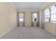 Empty bedroom with neutral walls, carpet flooring, and large windows at 2441 Prairie Dunes, Clermont, FL 34711