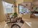 Bright breakfast nook with glass-top table and view of screened porch at 2441 Prairie Dunes, Clermont, FL 34711