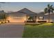 One-story house with a brick driveway, and a well-manicured lawn at 2441 Prairie Dunes, Clermont, FL 34711