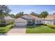 One-story home with tile roof, landscaped yard, and brick driveway at 2441 Prairie Dunes, Clermont, FL 34711