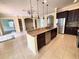 Kitchen island with granite countertop and seating at 2441 Prairie Dunes, Clermont, FL 34711