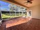 Spacious screened porch with tile flooring and ceiling fan at 2441 Prairie Dunes, Clermont, FL 34711