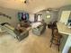 Open living room boasts neutral walls and carpet, comfortable seating, and views of the front door at 32676 Oak Park Dr, Leesburg, FL 34748