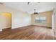 Bright living room featuring hardwood floors, neutral walls, a ceiling fan and sliding glass doors to the backyard at 439 Grovewood Pl, The Villages, FL 32162