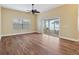 Bright living room featuring hardwood floors, neutral walls, a ceiling fan and sliding glass doors to the backyard at 439 Grovewood Pl, The Villages, FL 32162