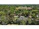 Overhead shot of the home surrounded by greenery and a distant sports field at 1635 Hilltop Dr, Mount Dora, FL 32757