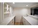 Elegant bar area features white marble countertops, custom cabinetry, and a beverage cooler at 1635 Hilltop Dr, Mount Dora, FL 32757