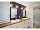 Modern bathroom with a double sink vanity, wood countertop, and a sleek, updated design at 1635 Hilltop Dr, Mount Dora, FL 32757