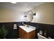 Stylish bathroom with wood vanity, modern fixtures, and a round mirror at 1635 Hilltop Dr, Mount Dora, FL 32757