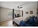 Bedroom featuring wood floors, a ceiling fan, and a window for natural light at 1635 Hilltop Dr, Mount Dora, FL 32757