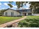 Charming two-story home with brick pathway, manicured lawn, and fresh white paint at 1635 Hilltop Dr, Mount Dora, FL 32757