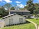Elegant home exterior with a brick pathway and well-kept garden beds at 1635 Hilltop Dr, Mount Dora, FL 32757