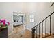 Inviting foyer with brick floors and staircase, offering a glimpse into a bedroom at 1635 Hilltop Dr, Mount Dora, FL 32757